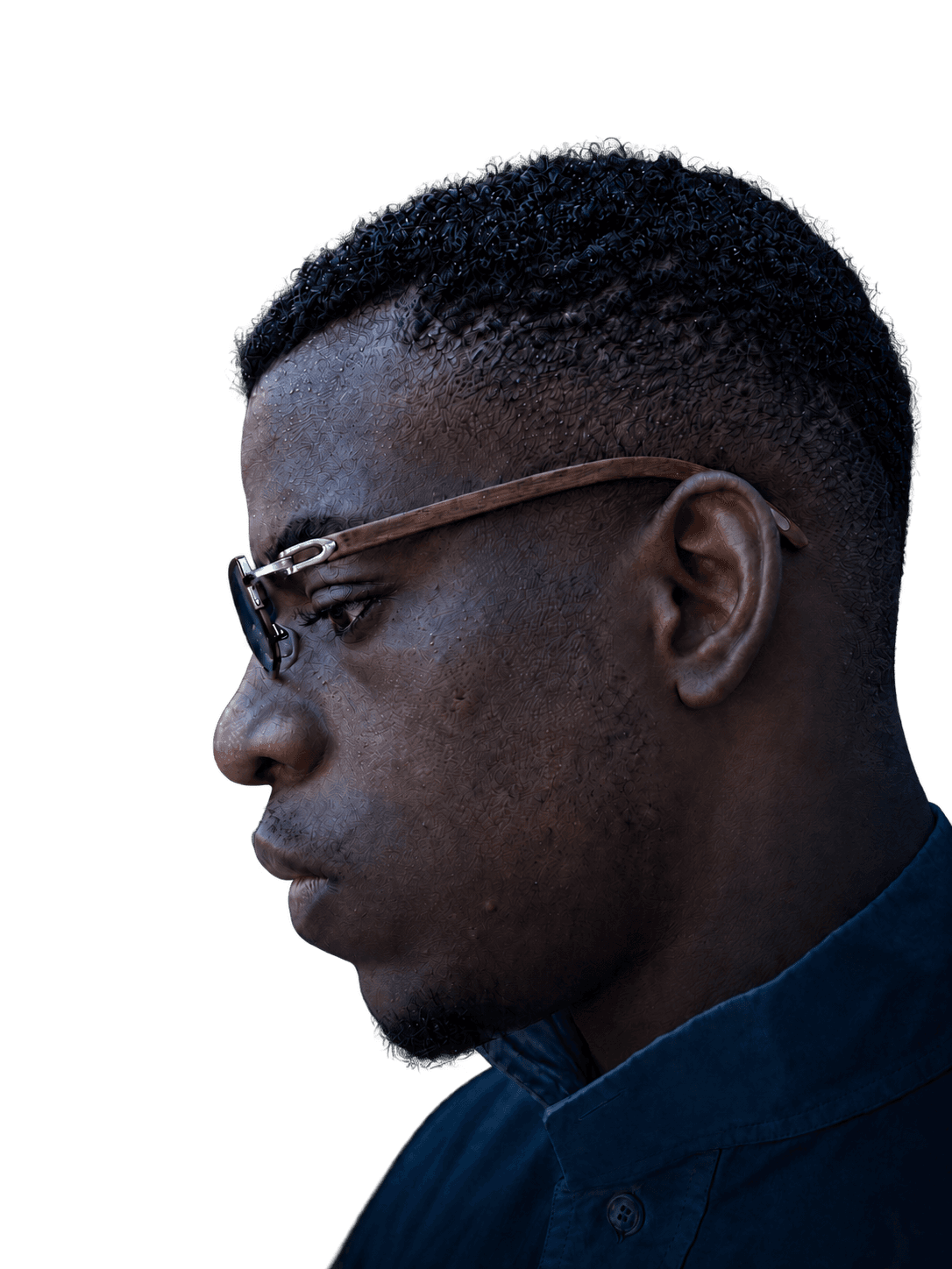Freeman Madudili, photographed in profile wearing glasses